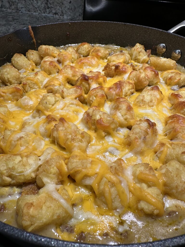 skillet of cheesy tater tot casserole