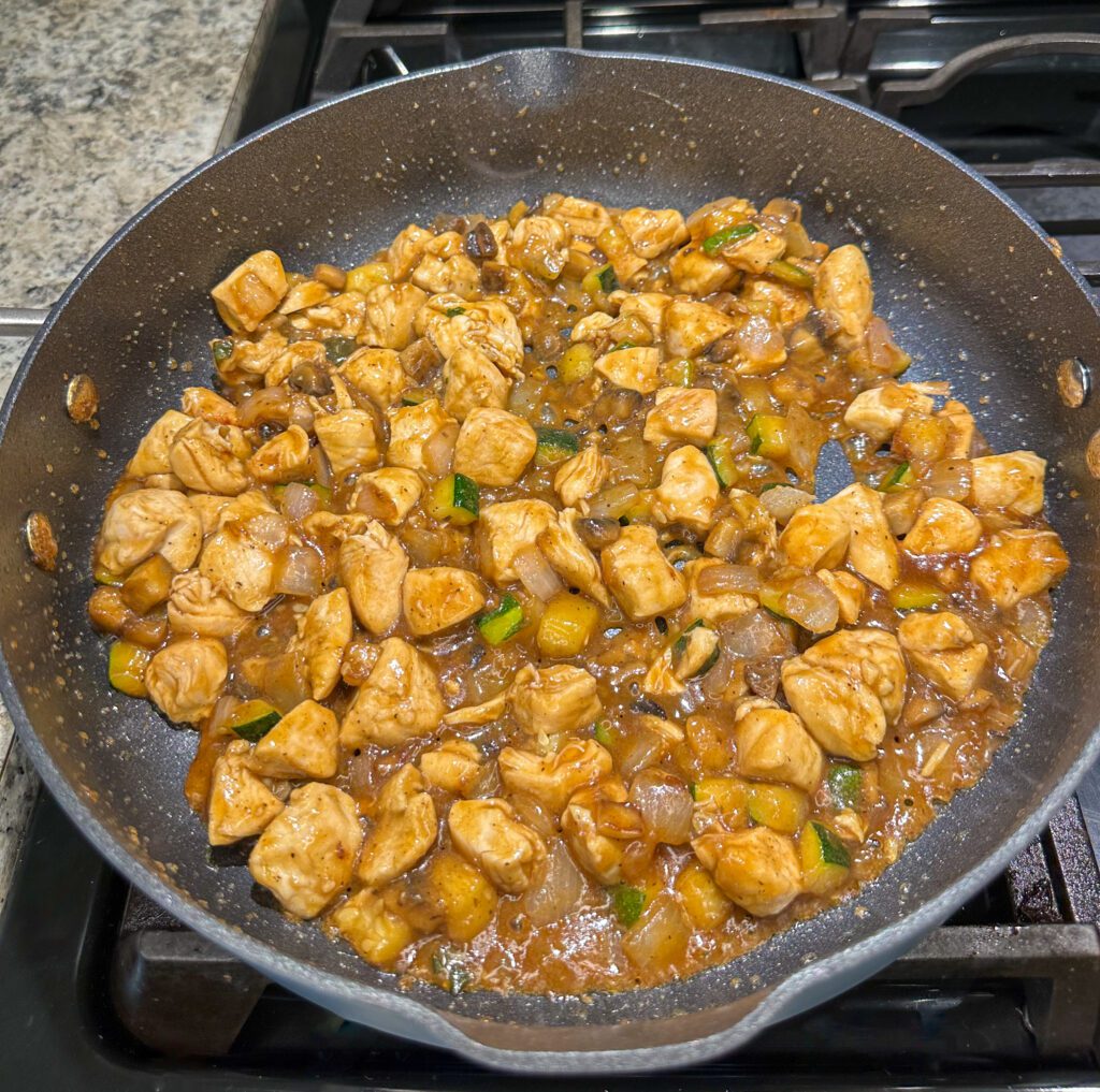 chicken cooking in teriyaki sauce