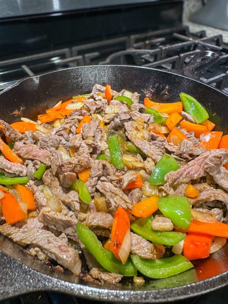 meat and vegetables in skillet