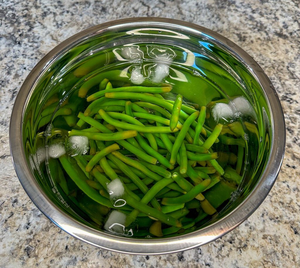 preboiled green beans in an ice bath